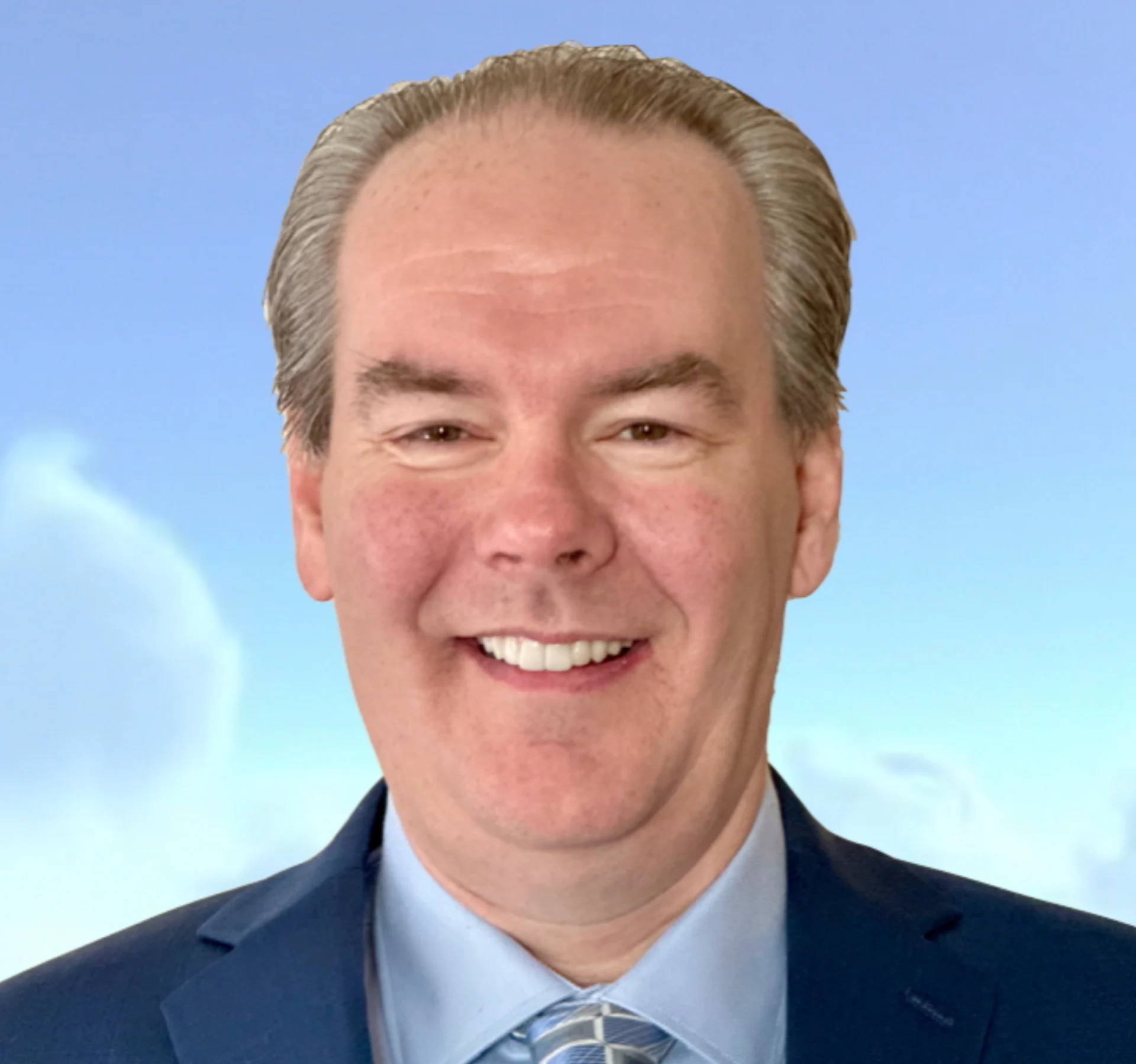 Smiling man in suit against blue sky.