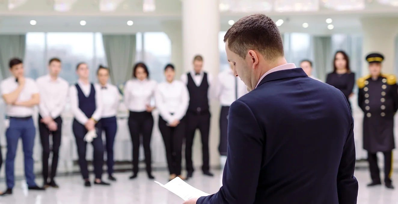 Man speaking to a group of people.